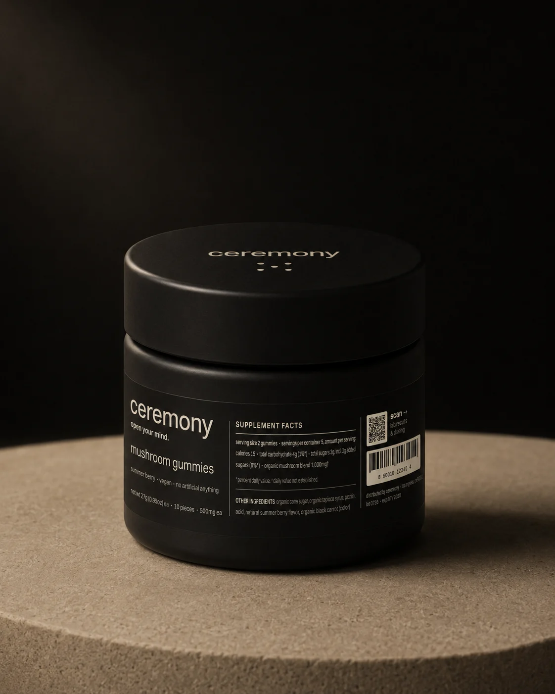 Ceremony mushroom gummies — matte black jar on a stone pedestal in warm low light